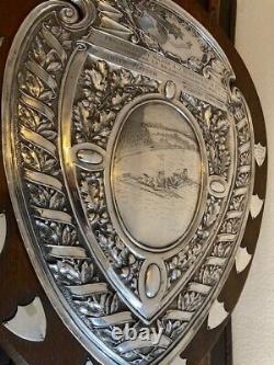 A wooden and silver plate sports shield circa 1917. Presented for shooting