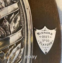 A wooden and silver plate sports shield circa 1917. Presented for shooting