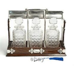 Antique Tantalus with 3 Cut Glass Decanters In Oak & Silver Plate Locking Frame