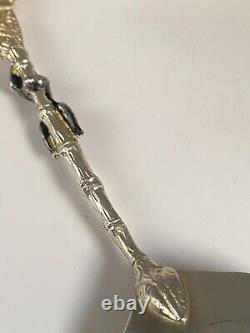 Antique c1907 Pair Ornate Gold Plated Serving Spoons as Palms Dark Metal Climber