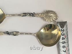 Antique c1907 Pair Ornate Gold Plated Serving Spoons as Palms Dark Metal Climber