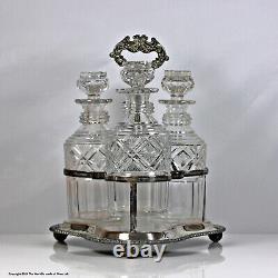 Early Victorian set of three cut glass cylinder decanters, silver plated stand