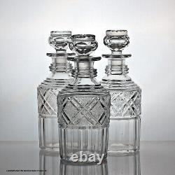 Early Victorian set of three cut glass cylinder decanters, silver plated stand