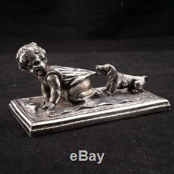 German silver plate paperweight of a child being pulled by a Dachshund Ca 1880