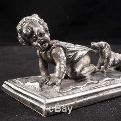 German silver plate paperweight of a child being pulled by a Dachshund Ca 1880