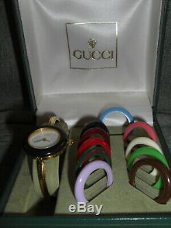 Gucci Ladies Gold Plated Watch with 11 Interchangeable Bezels. Original box
